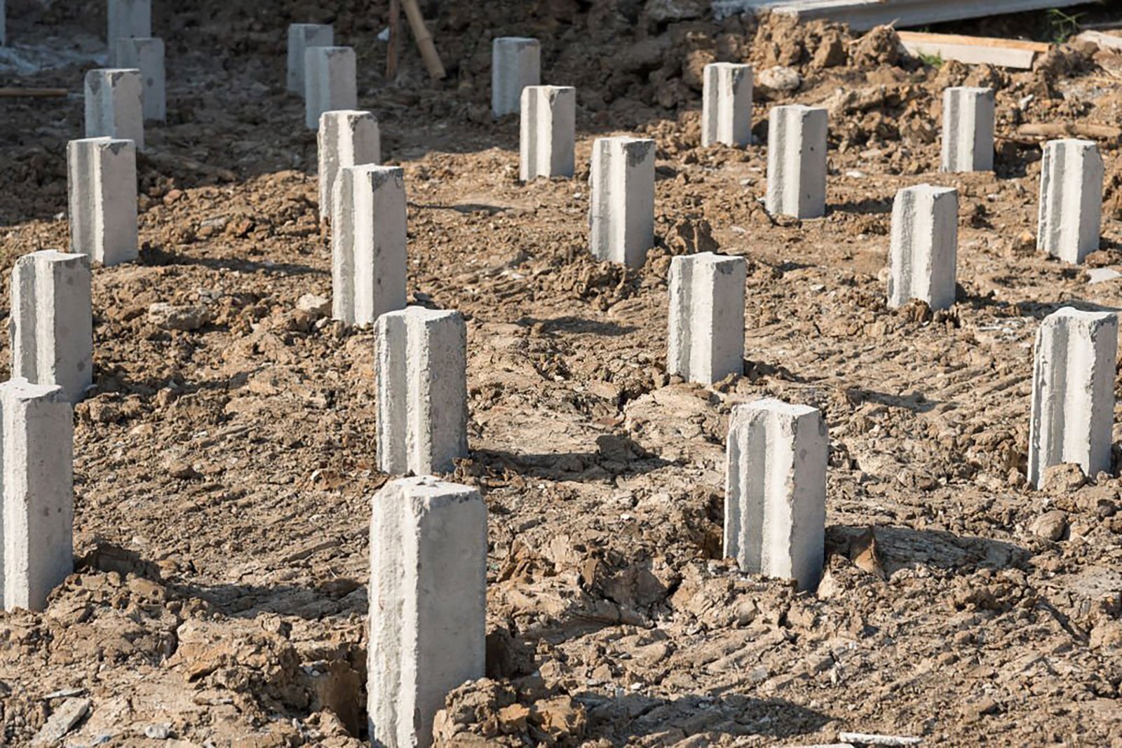 Concrete piles foundation under ground for a new building on construction site.