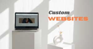 Laptop displaying a portfolio website with 'Work With Me' section, promoting custom website development services in a minimalist setting