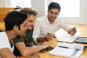 young-teacher-telling-two-students-about-corporate-budgeting_1262-15357