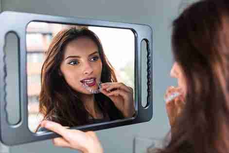 a girl wearing aligners