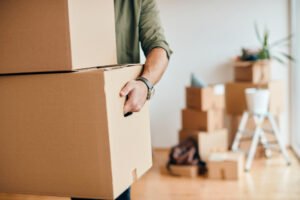 Man holding boxes, relocating to new apartment