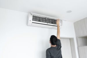 Man checking the interior of his aircon
