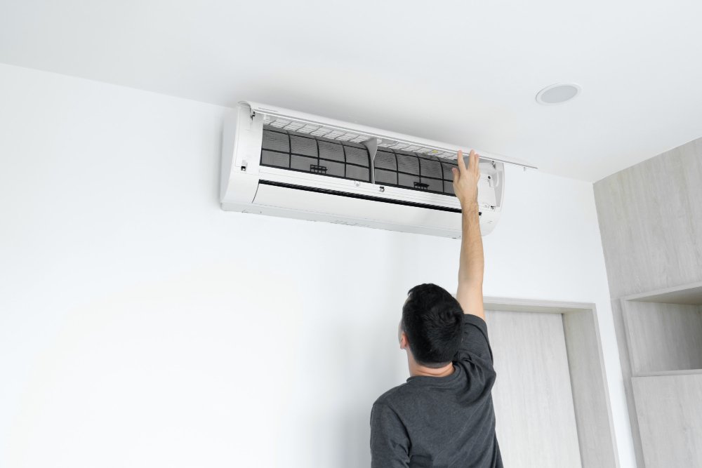 Man checking the interior of his aircon