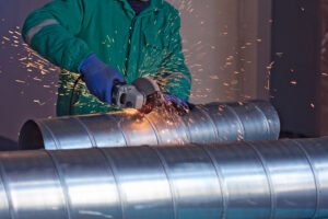 Man working on metal pipes
